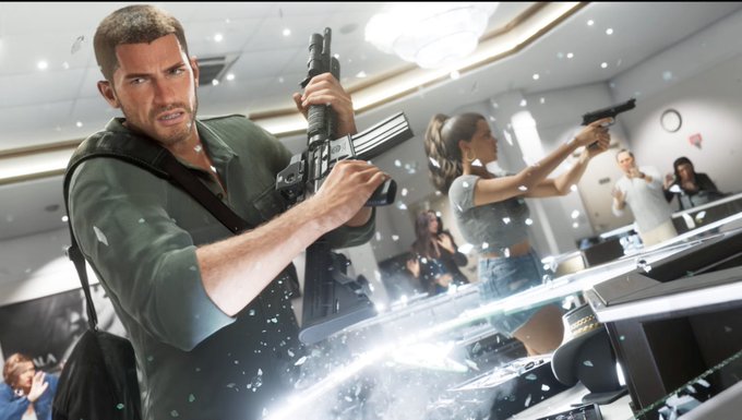 Two people with guns inside a glass office as the windows blow out.