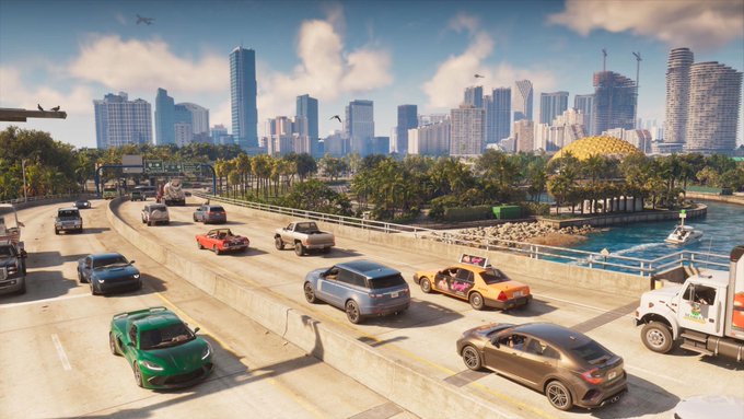 Traffic crossing a bridge toward a sunny downtown skyline.